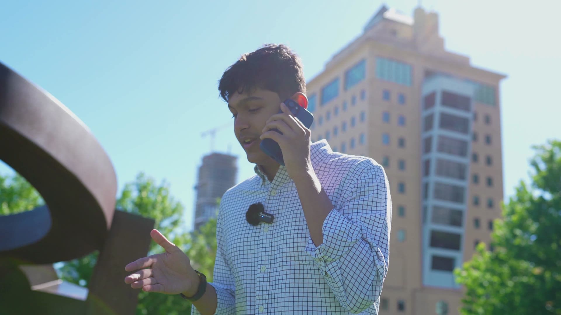 Adil Mukhi on a phone call outdoors in downtown Mississauga
