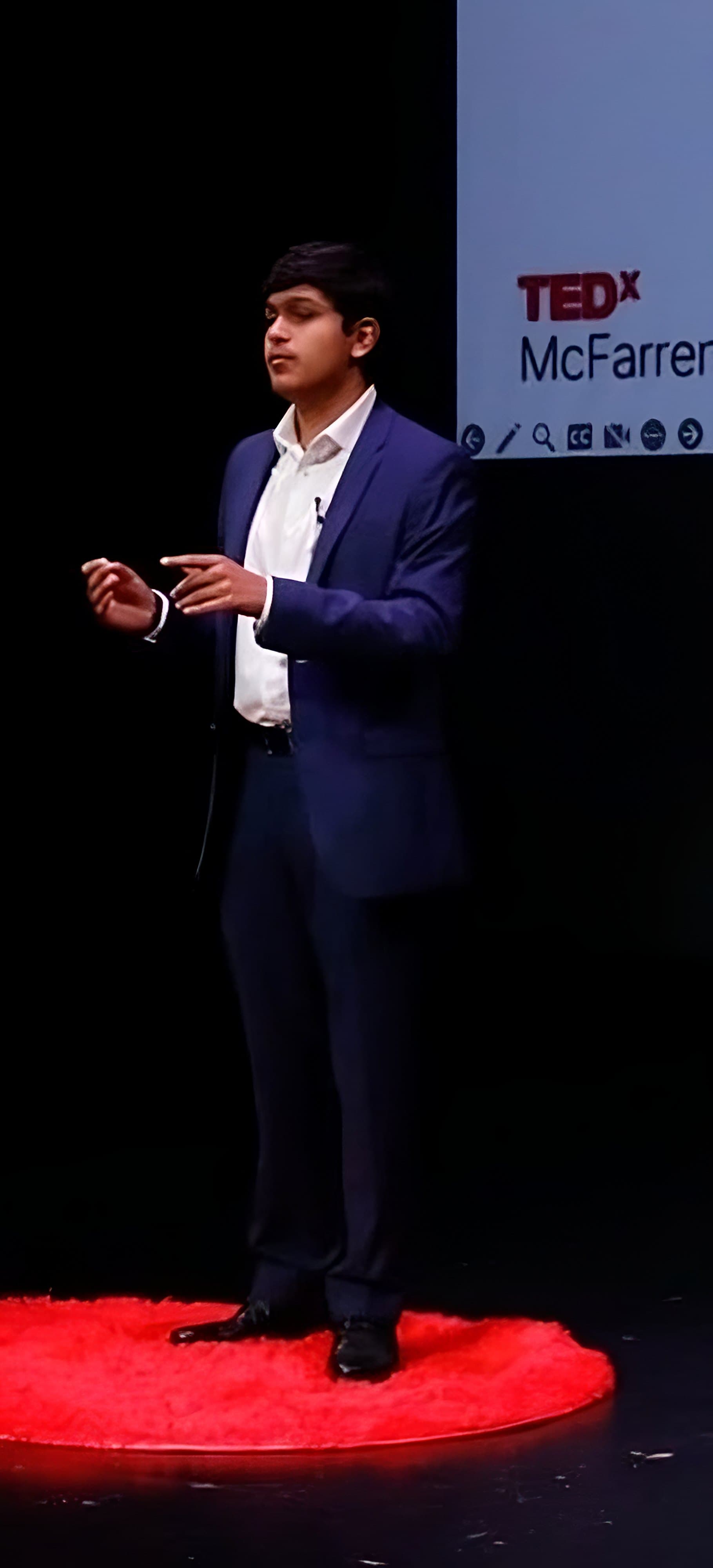 Adil Mukhi on the red circle at TEDx