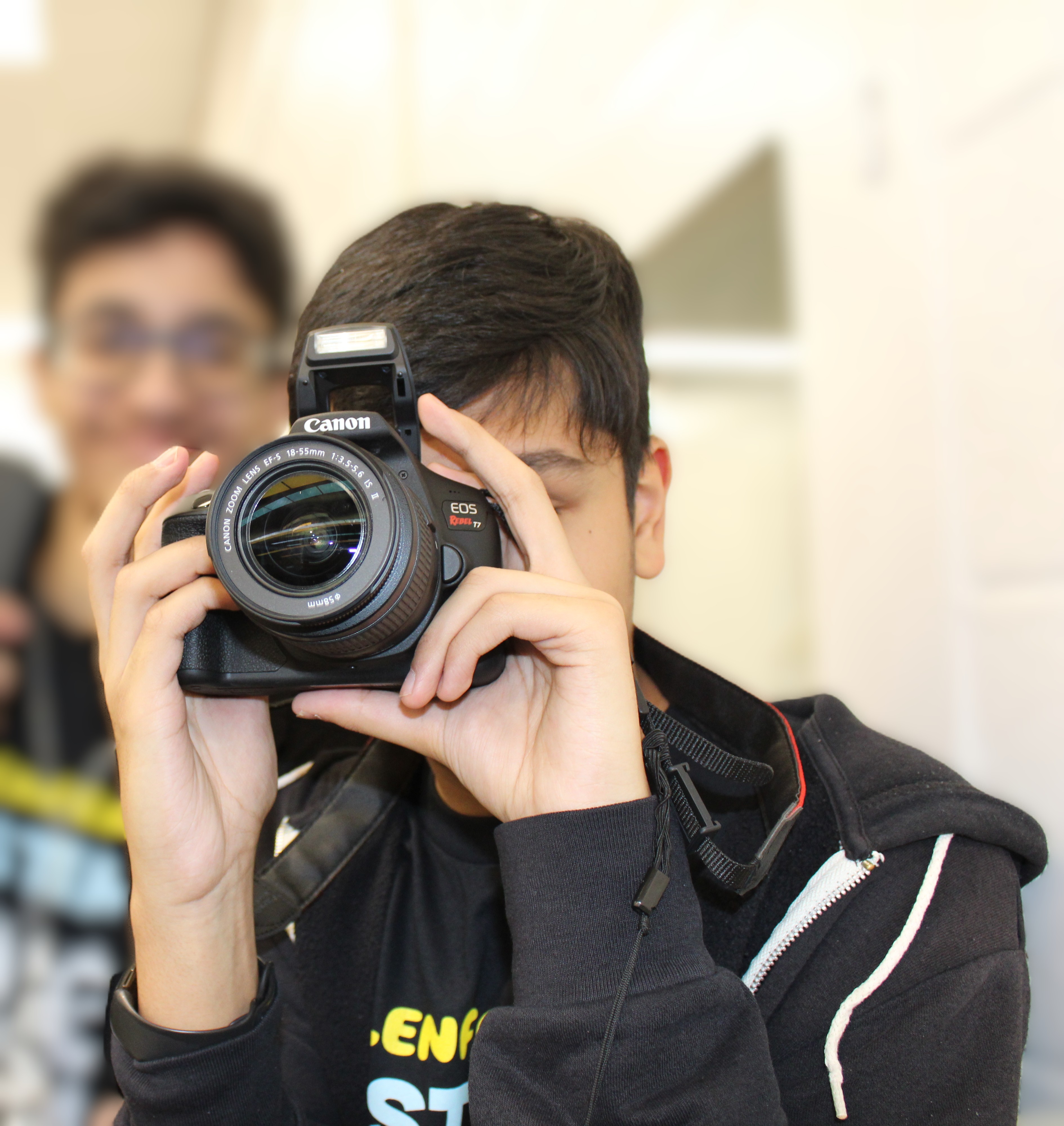 Adil Mukhi holding a camera