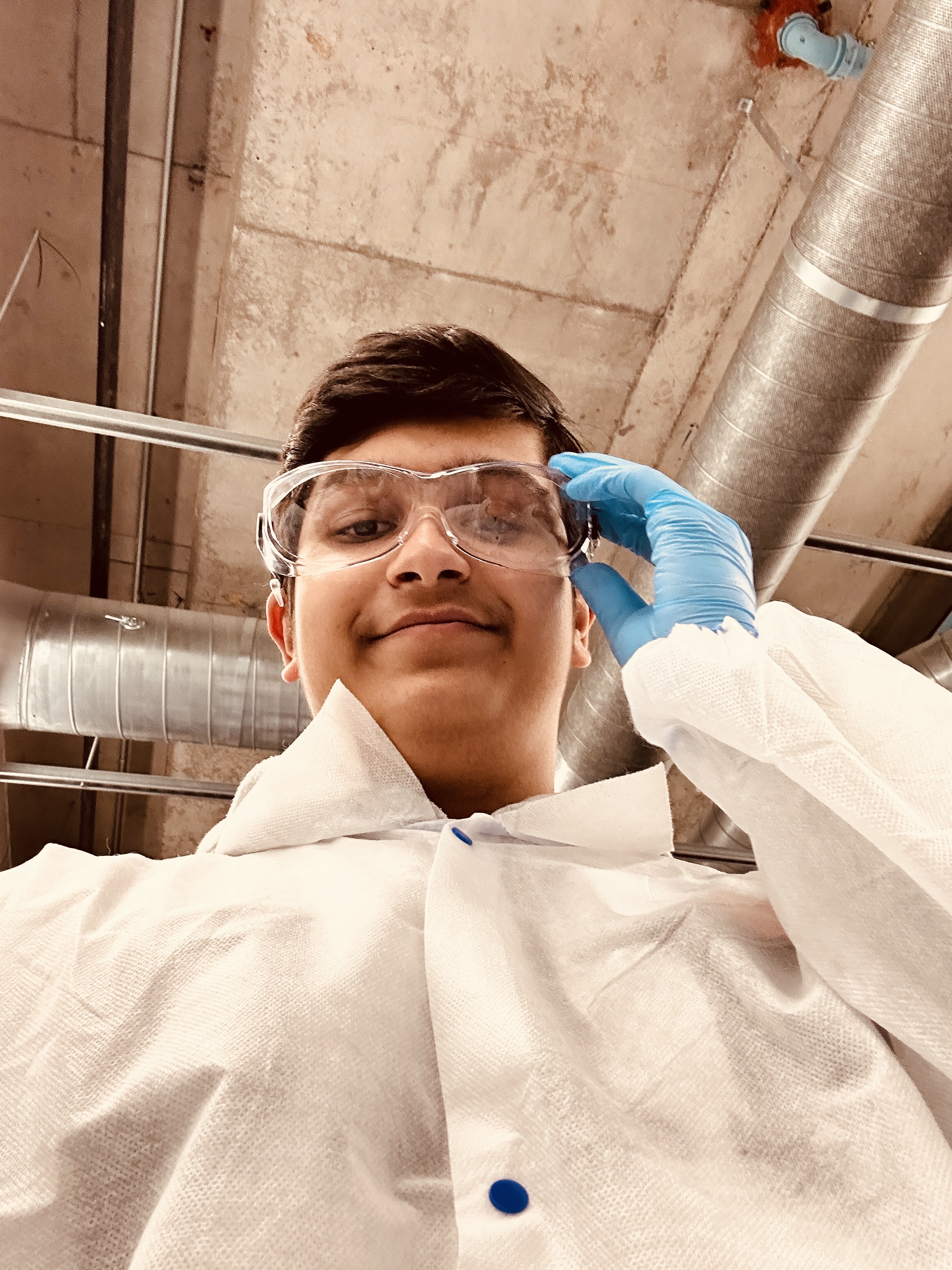 Adil Mukhi in a lab coat doing medical research