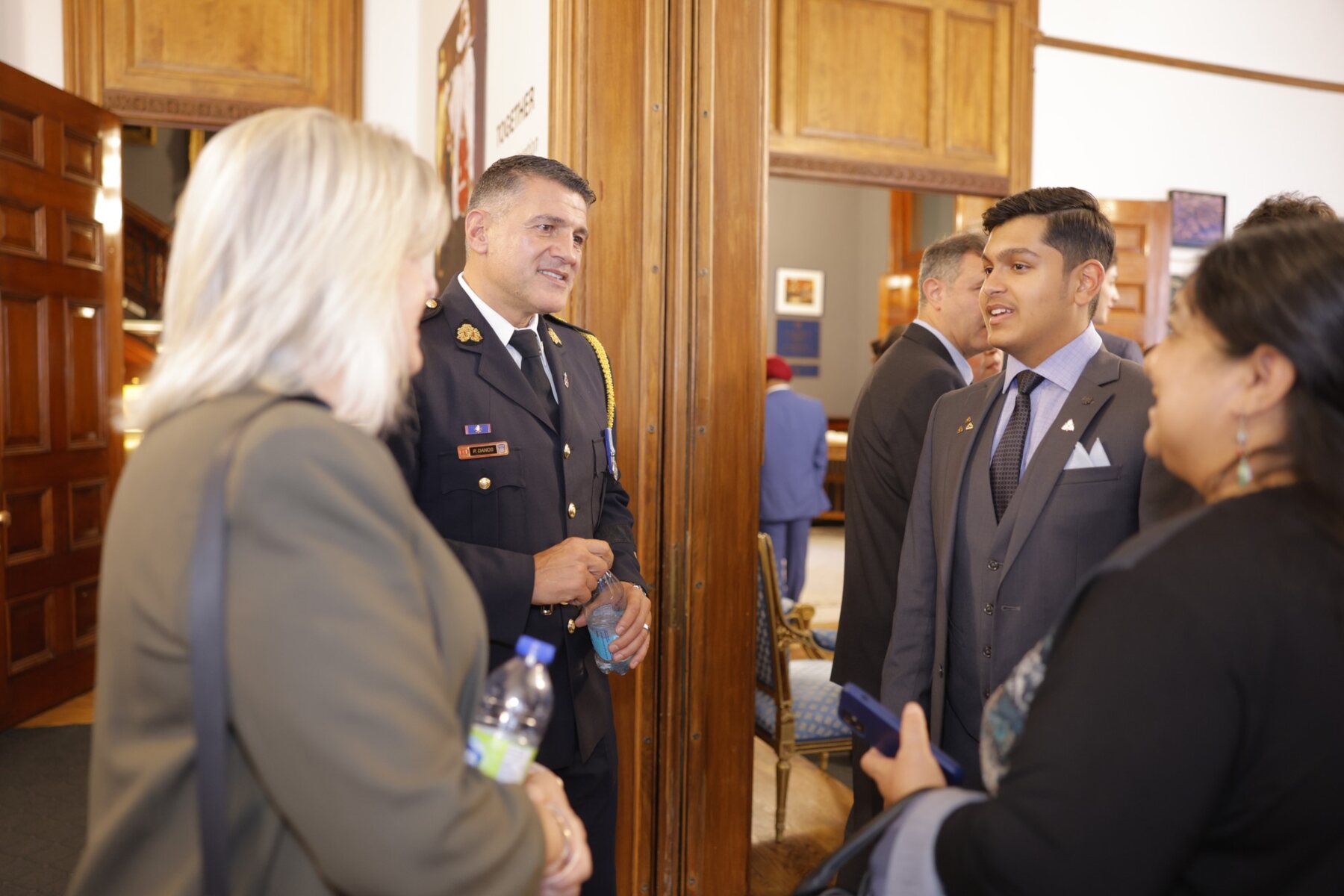 Adil Mukhi talking with guests at Queen's Park