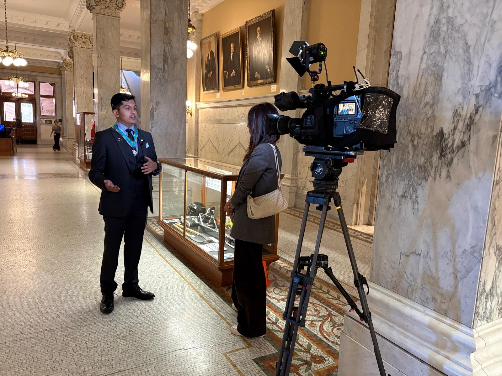 Adil Mukhi giving a television interview at Queen's Park