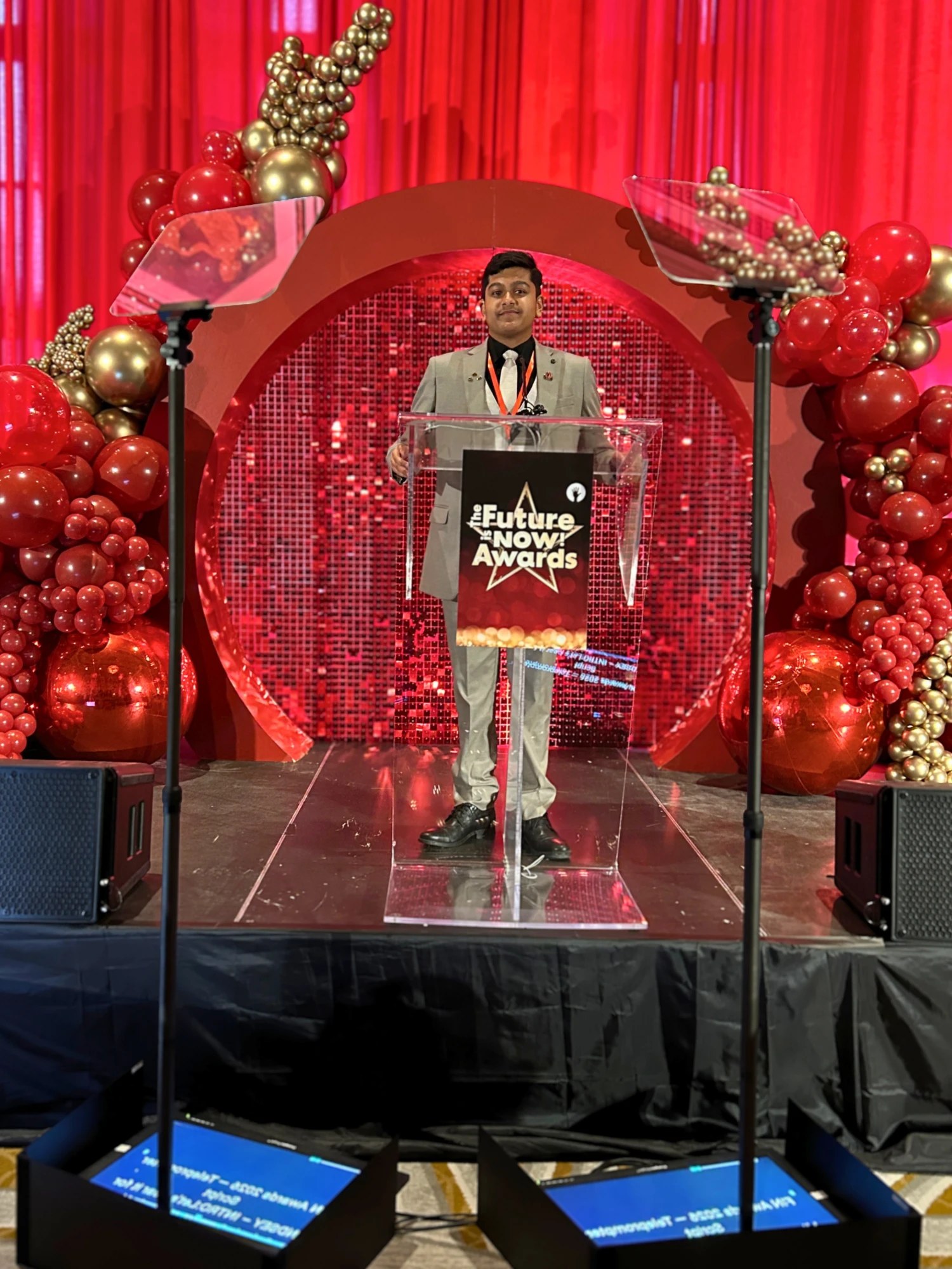 Adil Mukhi at the podium of The Future Is Now Awards